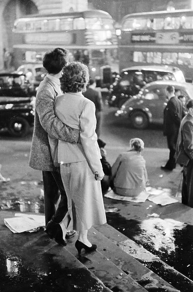 Rush Hour. December 1956: A young couple watch the world go by in Londons