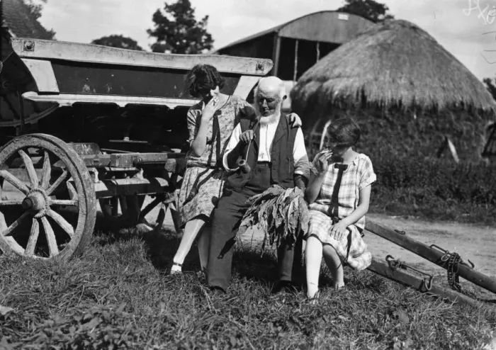 Framed Print : Rustic. September 1926: A farm worker relaxes with a pipe Framed Print : Rustic. September 1926: A farm worker relaxes with a pipe