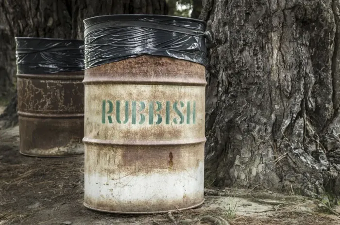 Framed Print : Rusty tin rubbish bin with word rubbish next to a gnarled tree, New Zealand Framed Print : Rusty tin rubbish bin with word rubbish next to a gnarled tree, New Zealand