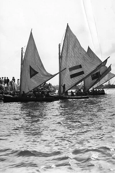 Sailboats. circa 1910: Yachtsmen furling their sails. (Photo by F J Mortimer / Getty Images)