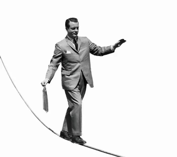 Framed Print : Salesman with briefcase walking tightrope Framed Print : Salesman with briefcase walking tightrope