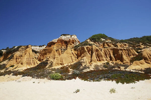 Sandstone rocks eroded by wind and rain, beach, Atlantic coast, near Melides, Portugal