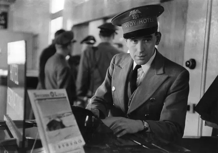 Framed Print : Savoy Rep. A representative from the Savoy Hotel waits to greet guests at London airport Framed Print : Savoy Rep. A representative from the Savoy Hotel waits to greet guests at London airport