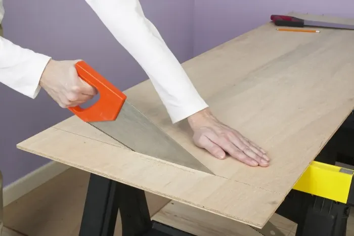 Framed Print : Sawing through plywood