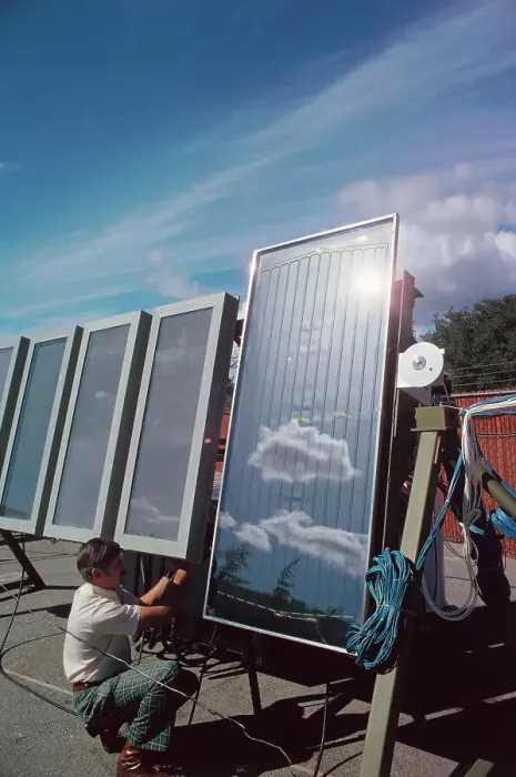 Framed Print : Scientist Checking Solar Panels Framed Print : Scientist Checking Solar Panels