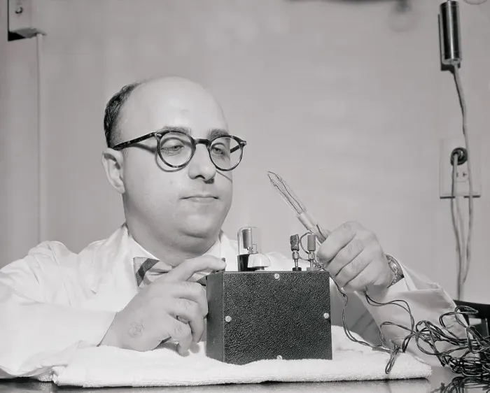 Framed Print : Scientist Demonstrating His Invention