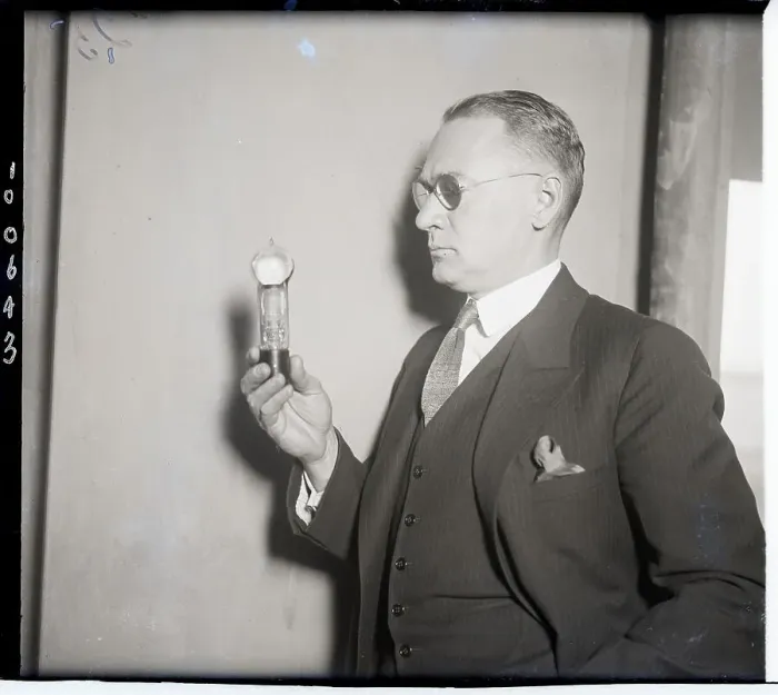 Framed Print : Scientist with Tube Which Controls Electric Current Framed Print : Scientist with Tube Which Controls Electric Current