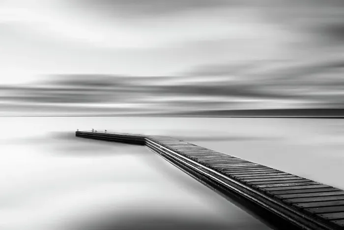 Framed Print : Jetty. Sea coast and jetty at sunrise leading out into still waters Framed Print : Jetty. Sea coast and jetty at sunrise leading out into still waters