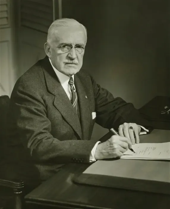 Framed Print : Senior businessman signing documents at desk, (B&W), portrait Framed Print : Senior businessman signing documents at desk, (B&W), portrait