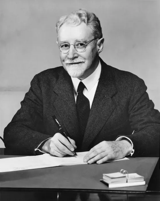 Framed Print : Senior businessman sitting at desk, writing, (B&W) Framed Print : Senior businessman sitting at desk, writing, (B&W)