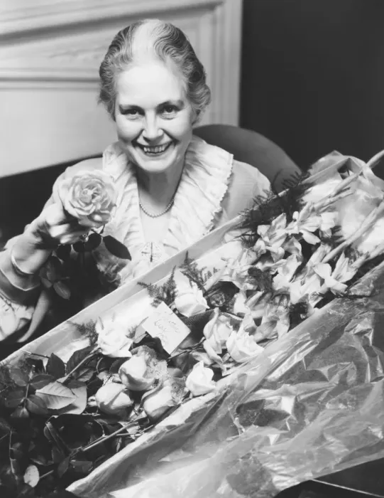 Framed Print : Senior woman holding boxed flowers, (B&W), portrait Framed Print : Senior woman holding boxed flowers, (B&W), portrait