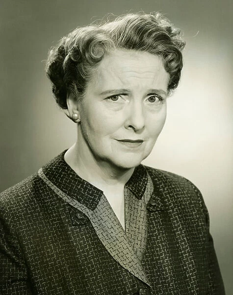 Senior woman posing in studio, (B&W), close-up, portrait