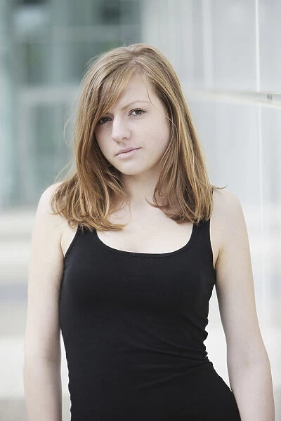 Sensual portrait of a young long-haired woman in a black tank top
