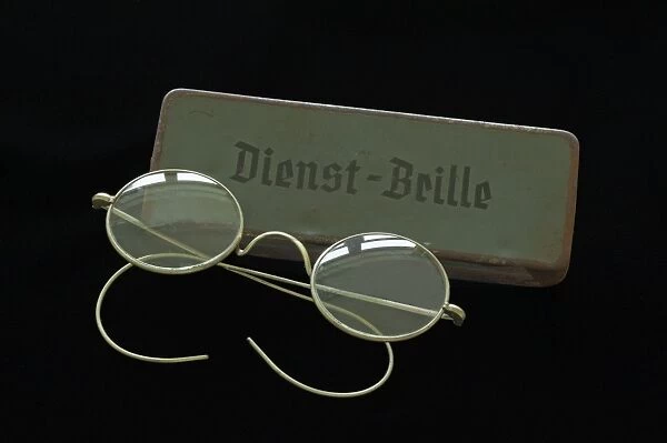 Service glasses from 1938 with a sheet metal case on black