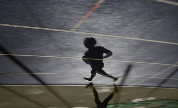 Shadow of a man running in sports stadium