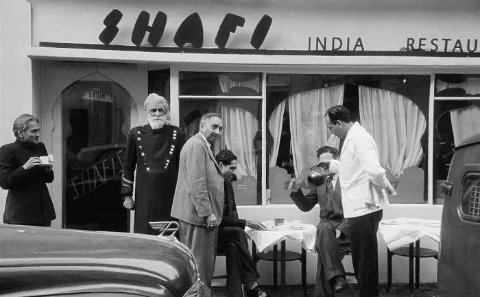 Framed Print : The Shafi. A Sikh doorman (left) outside the Shafi Indian restaurant in Gerard Street