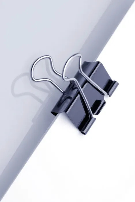 Framed Print : Sheet of paper with a paper clamp Framed Print : Sheet of paper with a paper clamp