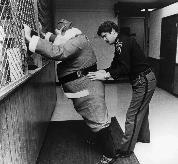 Framed Print : Sheriff Frisking Santa Claus Framed Print : Sheriff Frisking Santa Claus