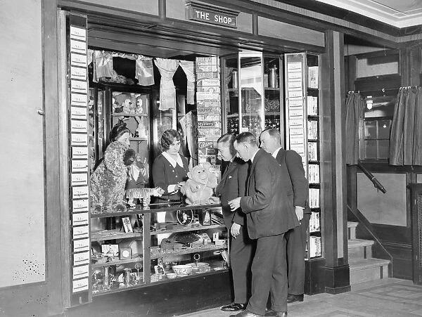 Ship Shop. A group of young gentlemen examine the cuddly toys on display