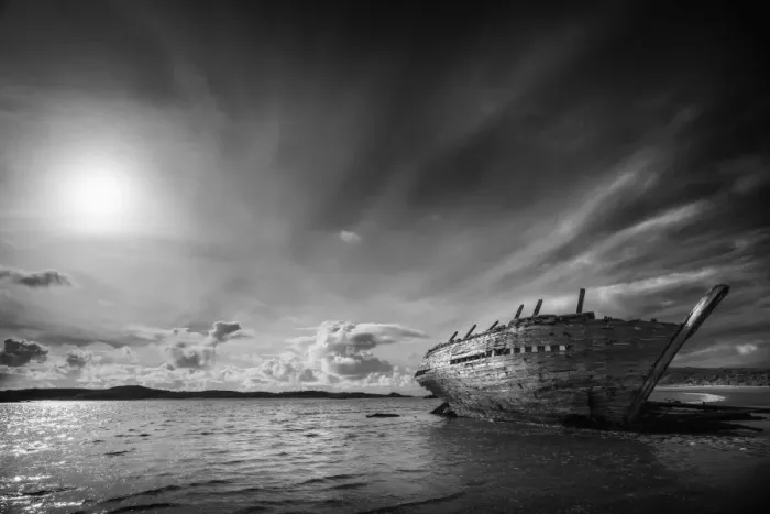 Framed Print : Shipwreck on beach under clouds Framed Print : Shipwreck on beach under clouds