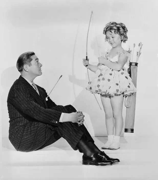 Framed Print : Shirley Temple Holding Bow With Jimmy Dunn Framed Print : Shirley Temple Holding Bow With Jimmy Dunn