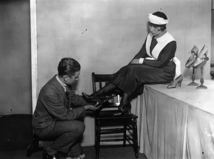 Framed Print : Shoe Fair. 5th September 1925: A waitress trying on a pair of the latest Framed Print : Shoe Fair. 5th September 1925: A waitress trying on a pair of the latest