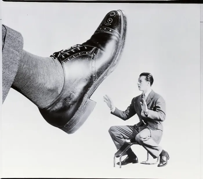 Framed Print : Shoe Salesman Faced with Giant Shoe Framed Print : Shoe Salesman Faced with Giant Shoe