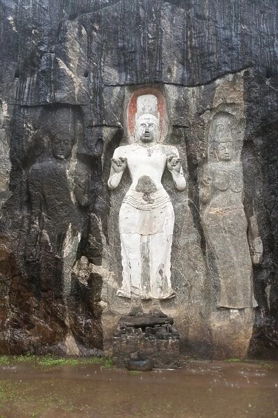 Shrine of Mahayana Buddhism, three old Buddha statues as rock reliefs, Avalokiteshvara in white, Tara on the right, Buduruvagala, Wellawaya, Monaragala Distrikt, Sri Lanka