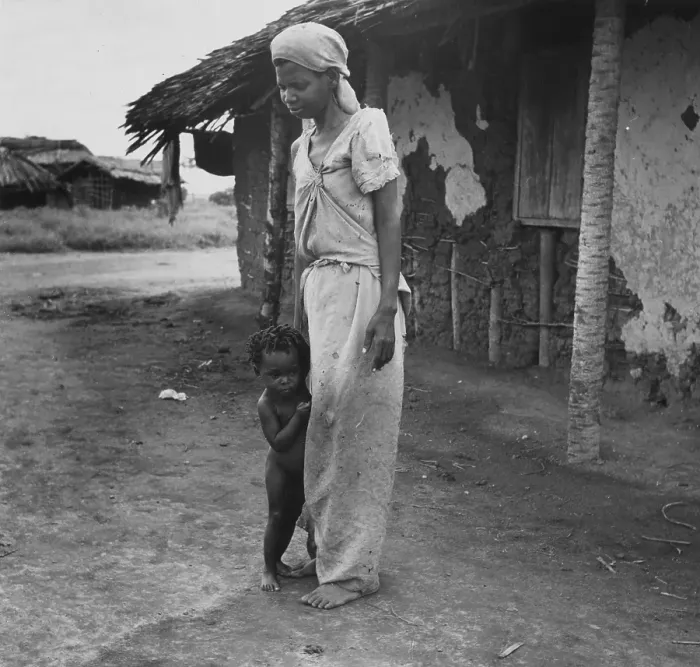 Framed Print : Shy Child. December 1951: A child hiding behind its mother at a fishing Framed Print : Shy Child. December 1951: A child hiding behind its mother at a fishing