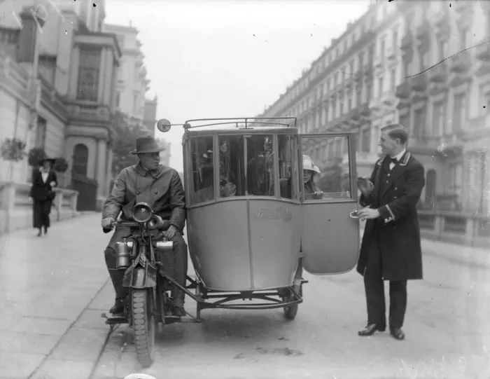 Framed Print : Sidecar. circa 1926: A young woman alights from an enclosed motorcycle sidecar Framed Print : Sidecar. circa 1926: A young woman alights from an enclosed motorcycle sidecar