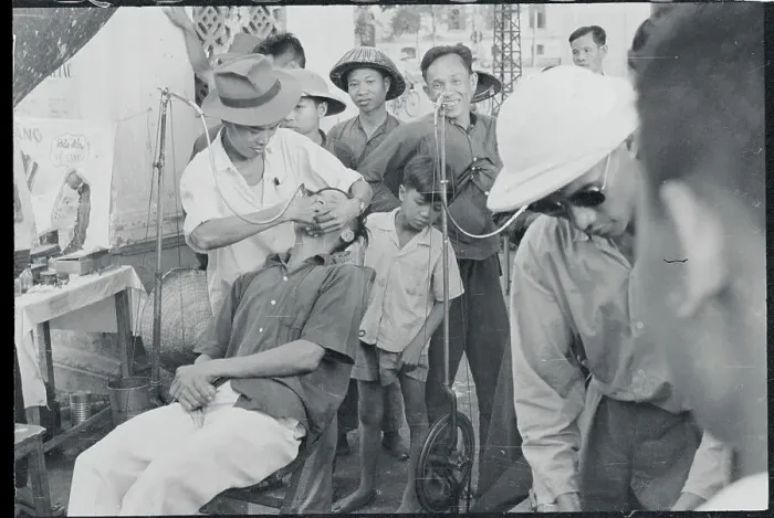 Framed Print : Sidewalk Dentist Tending to Patient