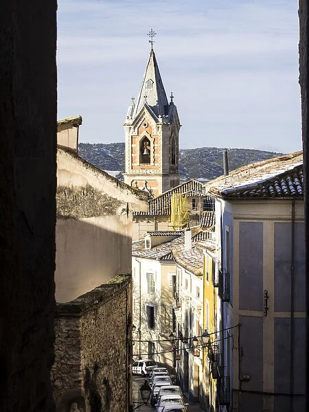 Sight of the Tower of the church of the Salvador in Cuenca, from inside an alley
