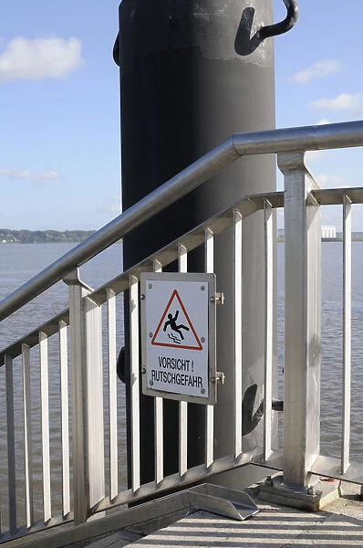 A sign Vorsicht Rutschgefahr, German for caution, slip hazard at the Hamburg harbour, Germany, Europe
