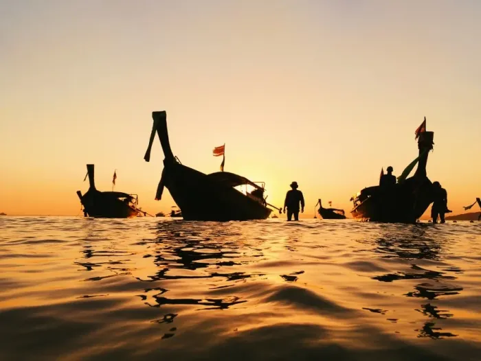 Framed Print : Silhouette of a longtail boat and fisherman at sunset in Krabi, Thailand Framed Print : Silhouette of a longtail boat and fisherman at sunset in Krabi, Thailand
