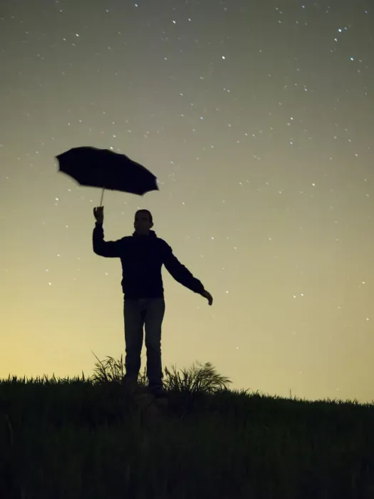 Framed Print : Silhouette of a man with an umbrella in the night Framed Print : Silhouette of a man with an umbrella in the night