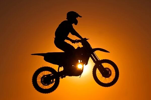 Silhouette of motocross at sunset