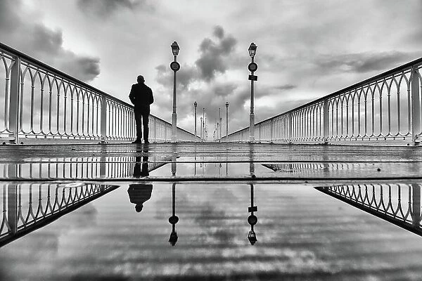 Silhouette on a pier on a rainy winter morning
