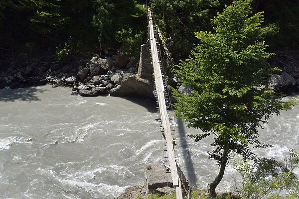 Simple suspension bridge over the Enguri river, Svaneti or Svanetia, Caucasus Mountains, Georgia