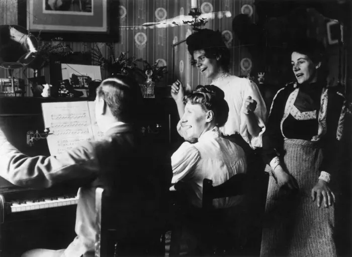 Framed Print : Sing-Song. 1908: A family have a sing-song round a piano Framed Print : Sing-Song. 1908: A family have a sing-song round a piano