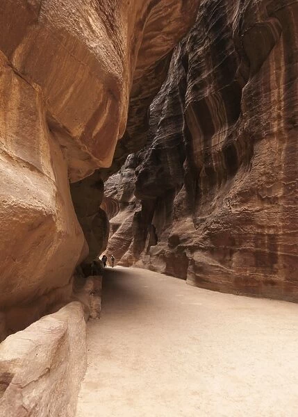 The Siq, the narrow canyon snakes its way towards Petra, Jordan
