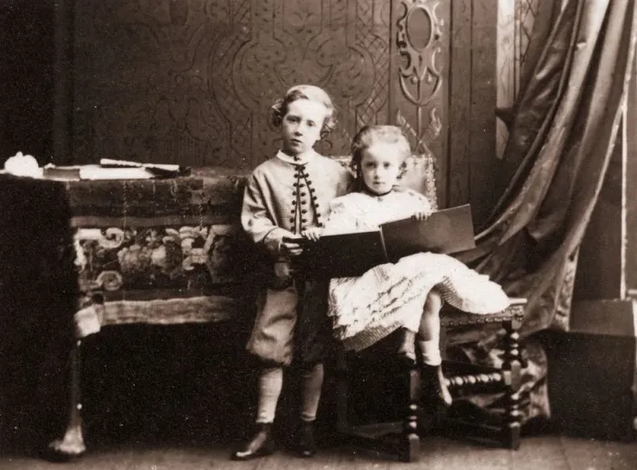 Framed Print : My Sister. circa 1860: A little boy shares a book with his sister Framed Print : My Sister. circa 1860: A little boy shares a book with his sister