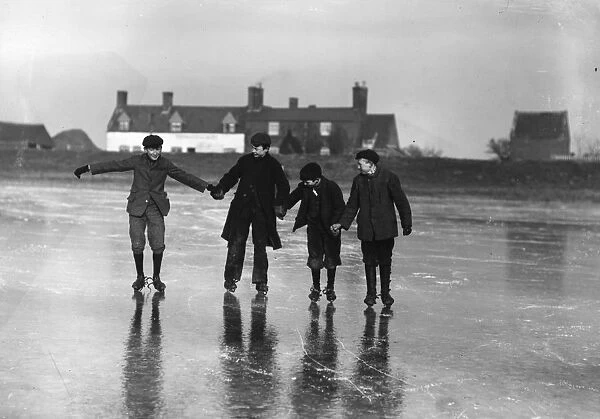 Skating. January 1907: Four lads skating hand in hand on the Cowpit Wash, Spalding