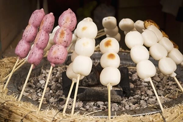Skewered Rice Balls Cooking Around A Grill