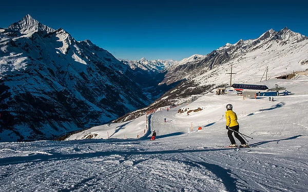 Ski track. People on ski track against snowy mountains