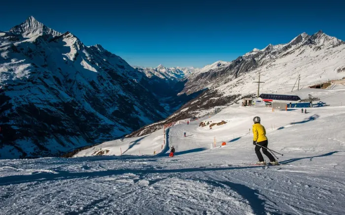 Framed Print : Ski track. People on ski track against snowy mountains Framed Print : Ski track. People on ski track against snowy mountains