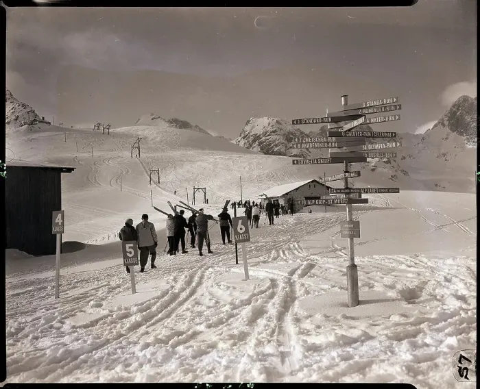 Framed Print : Skiers Walking Down Hill Towards Base Framed Print : Skiers Walking Down Hill Towards Base