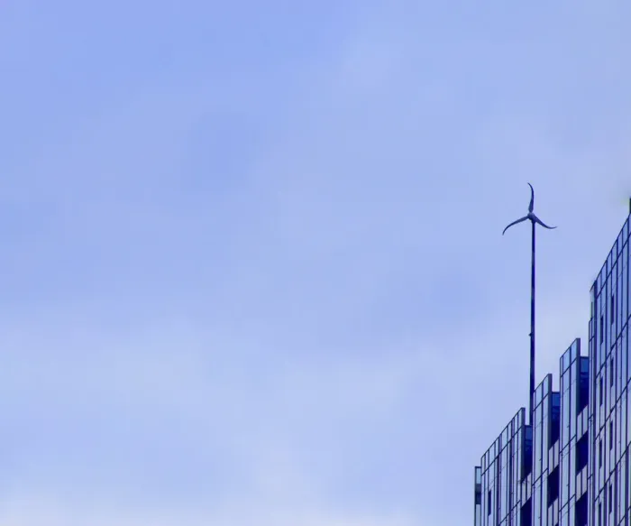 Framed Print : Sky Wheel. A color photo of a wind turbine on the roof of a skyscraper
