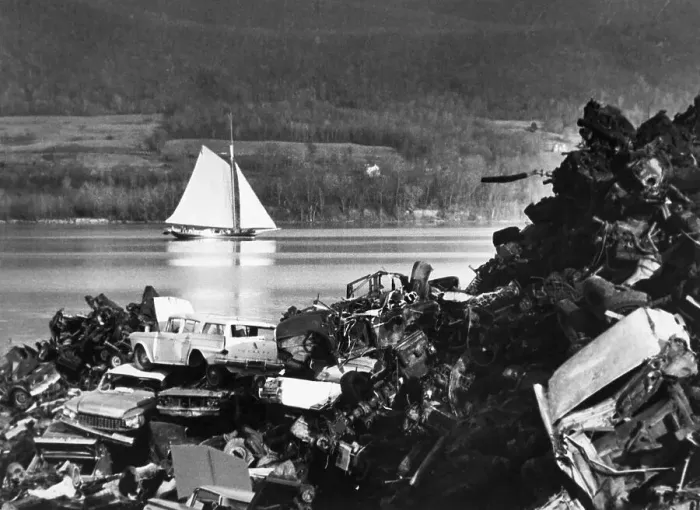 Framed Print : Sloop Sails Past Junkyard Framed Print : Sloop Sails Past Junkyard