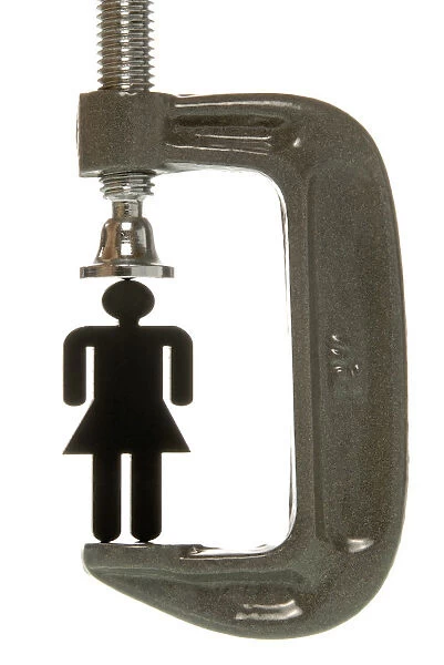 Small black female figurine in a screw clamp, symbolic image for being under pressure to perform