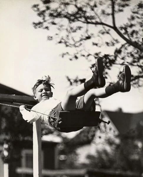 Small boy on swing outdoors